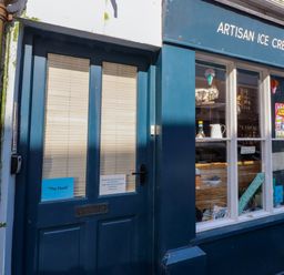 A shop front with a blue door and window at The Nook in Caernarfon
