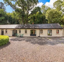 An outdoor view of a building with windows and doors at The Coach House Cottage Ballycommon