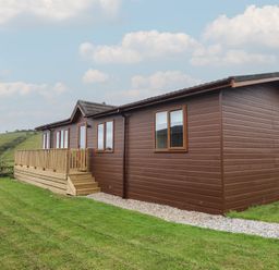 A building with a deck and windows at Lodge 19 in Torpoint
