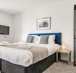 A bedroom with a bed and television at Cotswolds Apartment, sleeps 4 in Chipping Norton