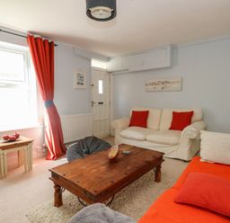 A living room with sofa and coffee table at Driftmark in Weymouth