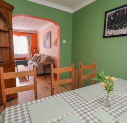 A dining room with a table and chairs at Hafan Deg in Holywell