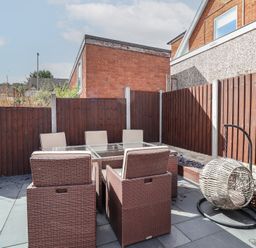 A garden with outdoor furniture and a hanging chair at Hafan Deg in Holywell