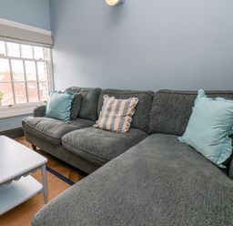 A snug with a sofa and coffee table at Apartment Blue in Whitby