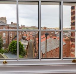 A view of rooftops and streets from a window at Apartment Blue in Whitby