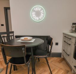 A kitchen with a table and chairs at Apartment Green in Whitby