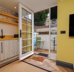 A kitchen with a counter and door leading to outdoor space at Apartment Yellow in Whitby