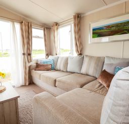 A living room with a sofa and coffee table at Roslenn in St Agnes