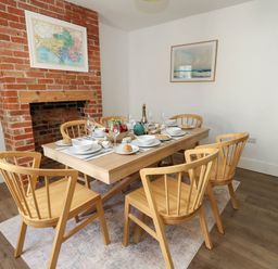 A dining room with table and chairs at The Watch House in Weymouth