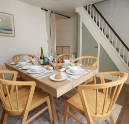 A dining room with a table set for meals at The Watch House in Weymouth