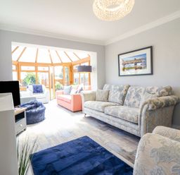 A living room with a sofa and chairs at Trefin in Cemaes Bay