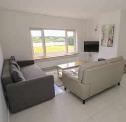 A living room with a sofa and coffee table at Tí Chonaill
