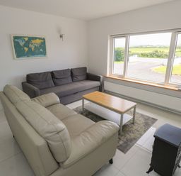 A living room with sofas and a table at Tí Chonaill