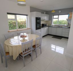 A kitchen with a dining table and chairs at Tí Chonaill in 