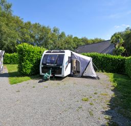 A caravan with an awning set up in a grassy area at Caravan in Dolton