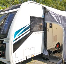 A caravan with an awning and steps at Caravan in Dolton