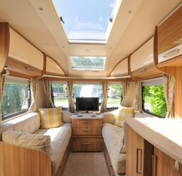 A living room with a couch and television in Caravan Dolton