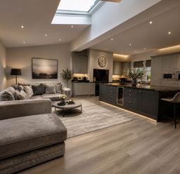 A living room with a sofa and kitchen island at Chowdene Lodge Estate