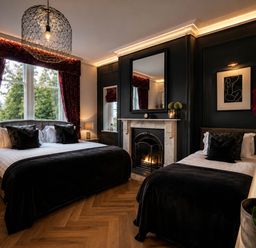 A bedroom with two beds and a fireplace at Chowdene Lodge Estate
