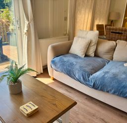 A living room with a sofa and coffee table at Lakeside Retreat in Newton Abbot