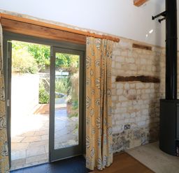 A living room with a door and curtains at Frome Gazey in Frampton