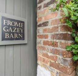A sign reading Frome Gazey Barn on a brick wall at Frome Gazey Barn in Frampton