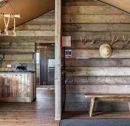 A kitchen with a wood panel wall and a bench at Luxury Safari Lodge Sleeps 4/6 Deer Park Dogs Ok Zeal Monachorum near Bow