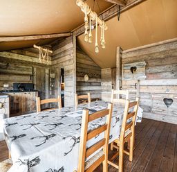 A dining room with a wooden table and chairs at Luxury Safari Lodge Sleeps 4/6 Deer Park Dogs Ok, Zeal Monachorum near Bow