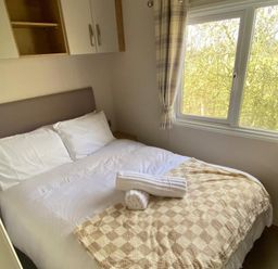 A bedroom with a double bed and window at the property
