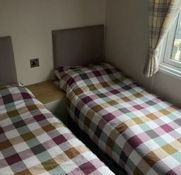 A bedroom with two single beds and a window at 
