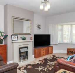 A living room with a television and fireplace at 3 Heath Park Brixham