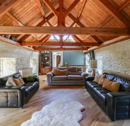 A living room with sofas and a coffee table at Yr Hen Felin in Boncath