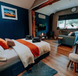 A bedroom with a bed and a sofa at TyCosy St Davids