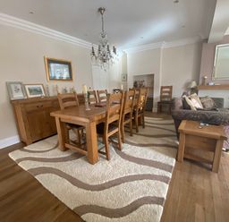 A dining room with a table and chairs at Harbour Lodge in Looe