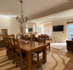 A dining room with a table and chairs at Harbour Lodge in Looe