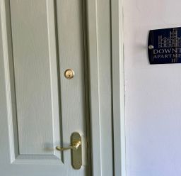 A door with a nameplate indicating Downton Apartments II in Alnwick