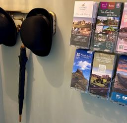 A wall with hats and brochures at Downton II Alnwick