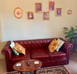 A sitting room with a sofa and wall art at Downton II in Alnwick