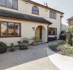 A house exterior with plants and path at Ty Traeth in Porthcawl