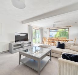 A living room with a sofa and dining area at Sleeps 9 KingBeds Family Friendly in Pityme near Penmayne