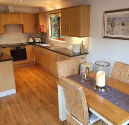 A kitchen with a dining table and chairs at Stunning 2 Bedroom Pet Friendly Lodge in Bridlington