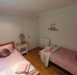 A bedroom with two beds and a small table at Stunning 2 Bedroom Pet Friendly Lodge in Bridlington