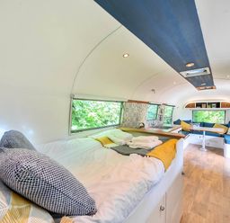 A living area with a bed and kitchenette in an accommodation at Sleeps 2 - Private Hot Tub - Fire Pit, St. Dogmaels near Cardigan
