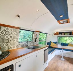 A living area with a kitchen and seating area at Sleeps 2 - Private Hot Tub - Fire Pit, St. Dogmaels near Cardigan