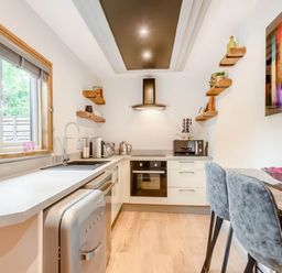 A kitchen with appliances and a table at Luxury 2 bedroom Lodge in rural lincolnshire
