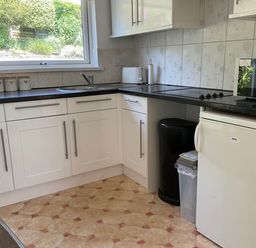 A kitchen with a sink and appliances at Bungalow Sleeps 2 Parking in Newquay