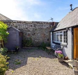 A garden with a gravel path, shed, and plants at 2 Bed Cottage Sleeps 4 Parking Wifi Darnick