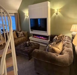 A living room with a sofa and television at 2 Bed Cottage Sleeps 4 Parking Wifi Darnick