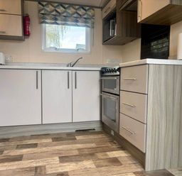 A kitchen with cabinets and appliances at Caravan in Holcot Sleeps 6 Max 6 people Max 4 adults per booking Pet Friendly Holcot near Moulton