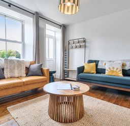 A living room with two sofas and a coffee table at Looe Cottage Seaside views log fire sleeps 4 Looe
